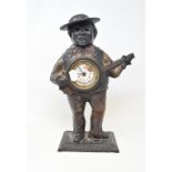 An American automaton clock, the cast metal case in the form of a banjo player, some damage, 39 cm