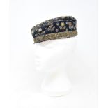 A velvet cap, embroidered with sequins, 26 cm wide, and other textiles (box)