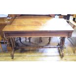 A 19th century rosewood table, with a frieze drawer, on turned legs joined by a pole stretcher,