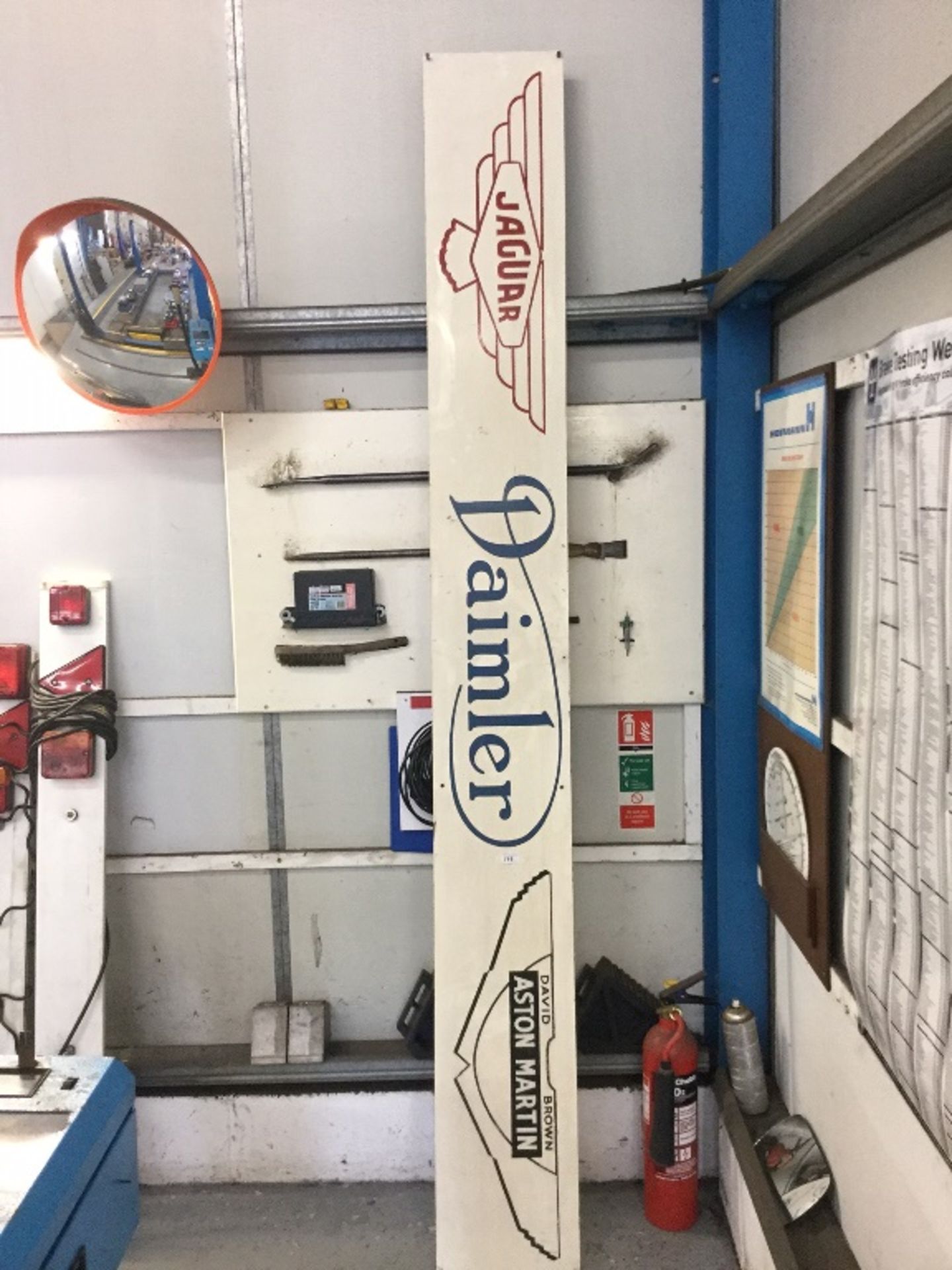 A large hand painted garage dealer sign for Aston Martin, Daimler and Jaguar