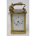 A carriage timepiece, the 5 cm enamel dial with Roman numerals, in a brass four pillar case, 14.5 cm