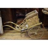 A late Victorian/early Edwardian doll's pram, with leatherette interior