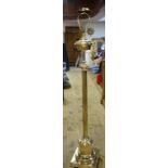 A late 19th/early 20th century brass standard lamp, with a reeded column, adapted for electricity,