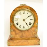 A mantel clock, in a walnut case, 30 cm high (over handle), two oil lamps, and a brass kettle (4)