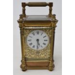 A carriage timepiece, the white dial with Roman numerals, in a brass case, 15.5 cm high (over