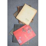 A collection of topographical and other postcards, in four albums and two Victorian photograph
