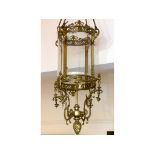 A large brass hall lantern, the shade of circular form with clear bevelled glass panels, on rope