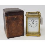 A carriage clock, in a leather travelling case, 15 cm high (over handle)