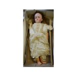 A Simon & Halbig bisque head doll, with sleeping brown eyes and open mouth exposing four teeth,