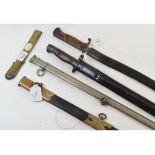 A Wilkinson bayonet, stamped 1907, with a scabbard, another bayonet, with associated scabbard, and