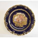 A Meissen porcelain plate, with painted and gilt decoration, broken and repaired, 22.5 cm