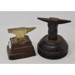 A jewellers brass anvil, on a wooden plinth, 7.5 cm high, and another similar (2)