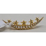 A crescent brooch, set seed pearls applied five gold stars with diamond centres, yellow coloured