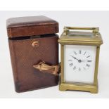 A carriage timepiece, the 6 cm wide enamel dial with Roman numerals, in a brass four pillar case,