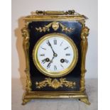 A mantel clock, the 9 cm diameter enamel dial with Roman numerals, fitted an eight day movement,