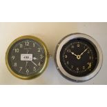 A Smiths ships bulkhead clock, the 12 cm black painted dial with Arabic numerals, in a brass case,