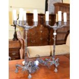 A pair of late 19th century bronze five light candelabra, adapted for electricity, on lioness head