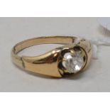 A diamond solitaire ring, in a yellow coloured metal mount, approx. ring size M½ Report by NG The