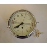 A ships bulkhead type clock, the 14 cm diameter painted dial with Arabic numerals signed N V