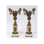 A pair of French Empire style brass and marble four light candelabra, in the form of winged