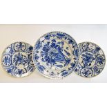 A pair of Dutch Delft plates, decorated foliage, 23.5 cm diameter, and another similar, 30.5 cm