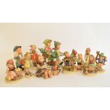 A Hummel group, Tree Trimming Time, BH12, and twelve other Hummel figures, Postboy, arm glued (13)