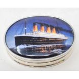 An oval silver pill box, applied a plaque of Titanic, 5.5 cm wide Report by NG Modern