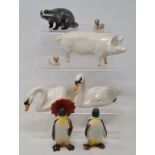 A Beswick Swan, head up, 1684, another, head down, 1685, two Cygnets, 1686 and 1687, a Badger, 3393,