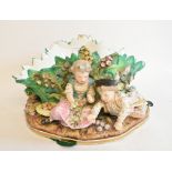 A late 19th century Meissen style porcelain table centrepiece, with four children and foliage,