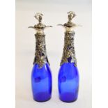 A pair of blue glass bottles, with vine plated mounts and stoppers, 28 cm high (2) Modern