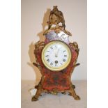 A Louis XVI style mantel clock, the 8 cm diameter enamel dial with Roman numerals, fitted an eight