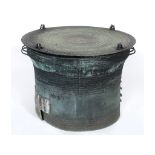 A Burmese bronze rain drum, of wasted circular form, the central stellar motif enclosed by