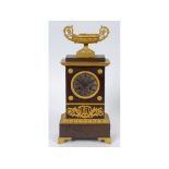 A 19th century French mantel clock, the 8.5 cm diameter silvered dial with Roman numerals, fitted an