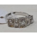 An Art Deco style platinum and seven stone diamond ring, approx. ring size K½ See illustration