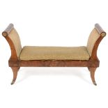 A 19th century Regency style mahogany window seat, on sabre legs with brass castors, 124 cm wide See