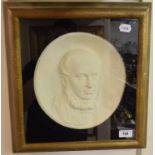 A Victorian plaster roundel of a gentleman, 25 cm diameter, in a cushion frame