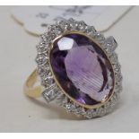 A 9ct gold, oval amethyst and diamond cluster ring, approx. ring size P½ Report by NG Modern