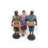 A pair of carved and painted wood blackamoor figures, in the form of a male and female attendant,