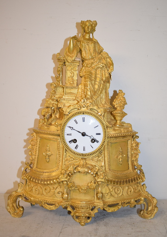 A 19th century French mantel clock, the 7.5 cm diameter enamel dial with Roman numerals, fitted an