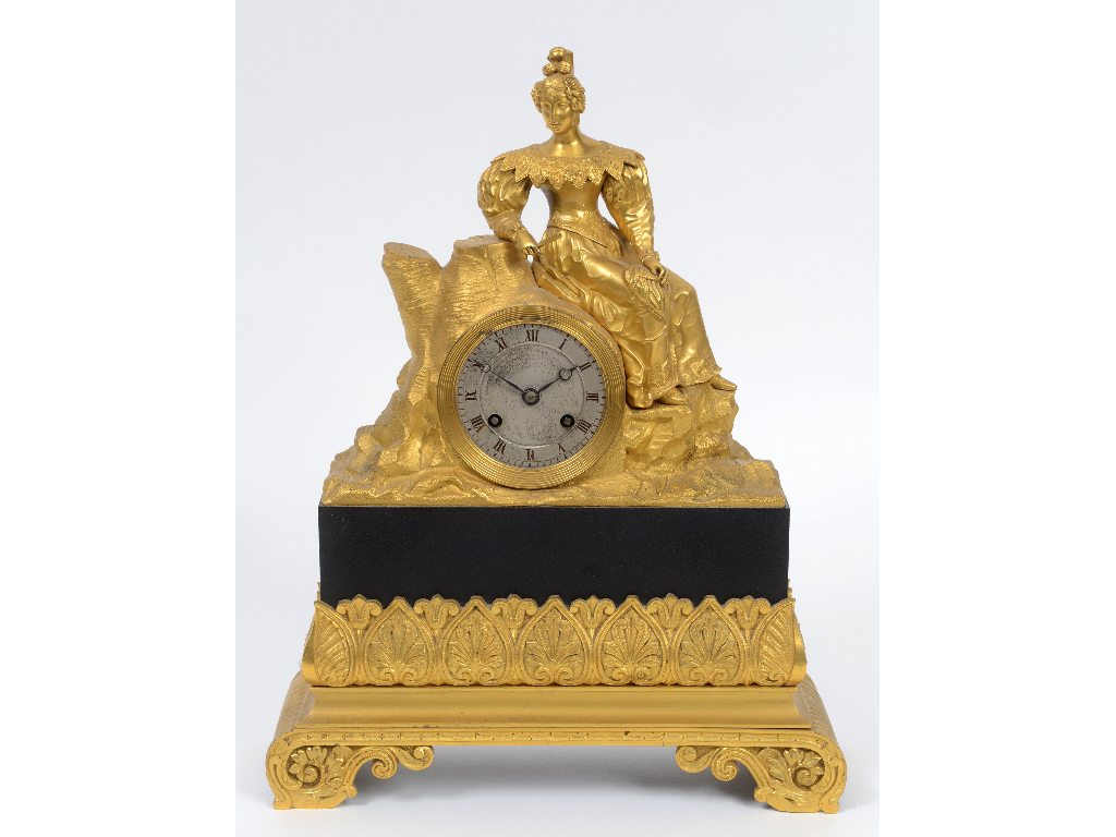 A 19th century French mantel clock, the 7 cm diameter silvered dial with Roman numerals, fitted an