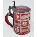 A 19th century Bohemian ruby flash glass tankard, decorated named properties, with pewter mounts,