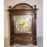 An Edwardian mantel clock, the 17 cm square brass dial signed J W Benson, Ludgate Hill, London, with