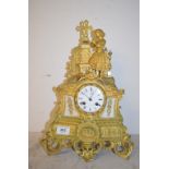 A late 19th century French mantel clock, the 7 cm diameter enamel dial with Roman numerals, fitted