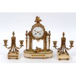 A clock garniture, the clock having a 10 cm diameter enamel dial with Arabric numerals, fitted an