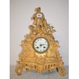 A late 19th century mantel clock, the 7 cm diameter dial with Arabric numerals, in a gilt spelter