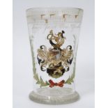 A German drinking glass, painted an enamel crest and dated 1669, chipped, 15.5 cm high See inside