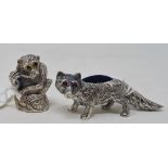 A novelty silver pin cushion, in the form of a fox, 2.5 cm high, and another similar in the form