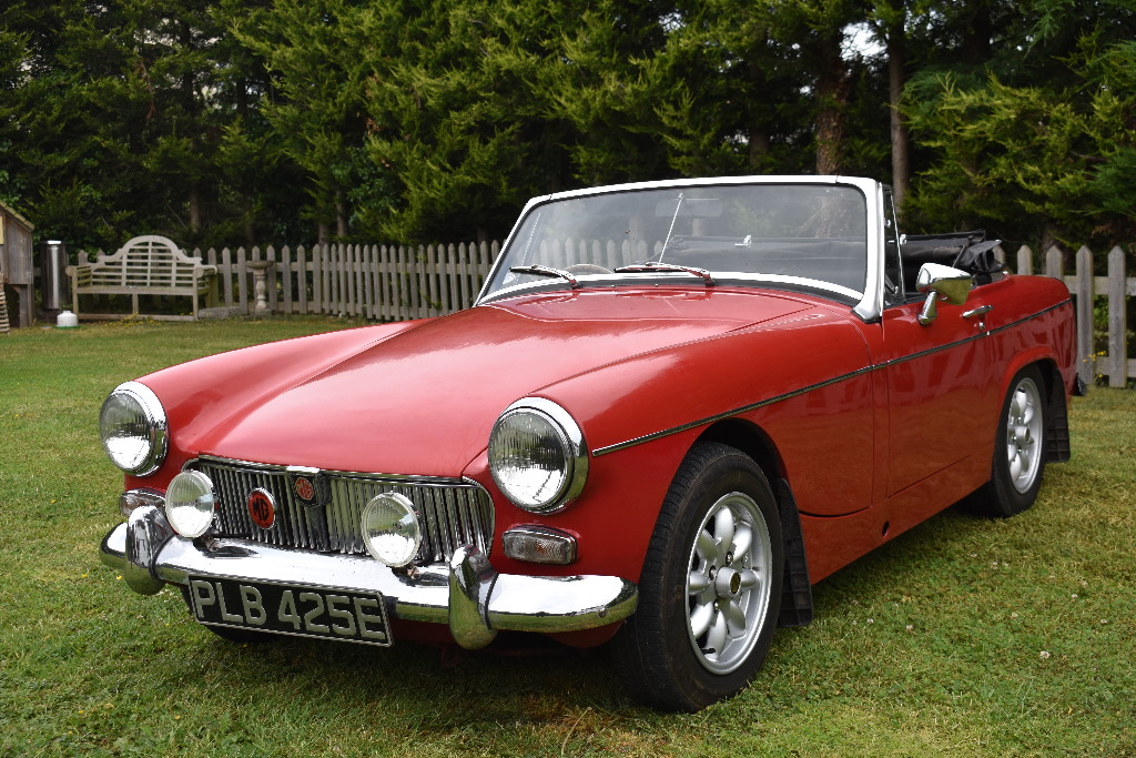 A 1967 MG Midget Mk III, registration number PLB 425E, red. The MG Midget is a no frills two seat