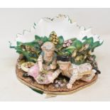 A late 19th century Meissen style porcelain table centrepiece, with four children and foliage,