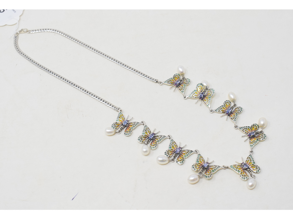 A silver, tanzanite, and pearl butterfly necklace Modern